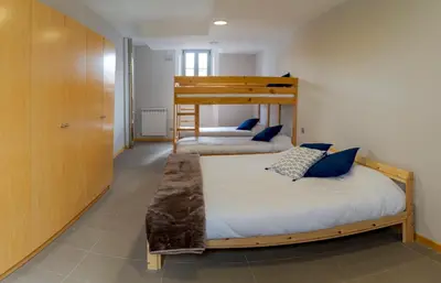 a bedroom with two bunk beds in a room at Albergue de Cerceda in Cerceda