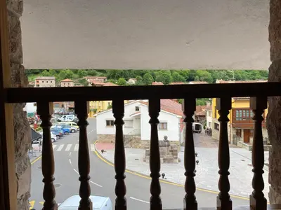 a view of a city street from a balcony at La Casina de Somiedo in Pola de Somiedo