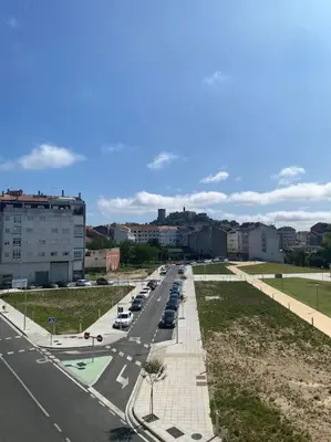 a street with cars parked on the side of a road at O Lar de Jose in Monforte de Lemos