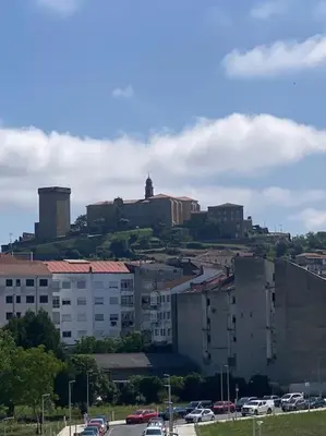 a city with buildings and cars on a street at O Lar de Jose in Monforte de Lemos