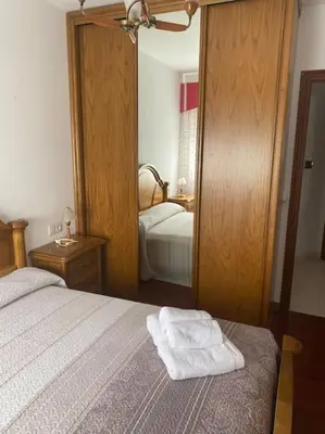 a bedroom with a bed with two towels on it at O Lar de Jose in Monforte de Lemos