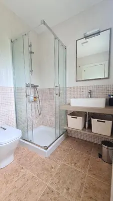 a bathroom with a glass shower and a sink at VUT Sierra Pambley in Villablino