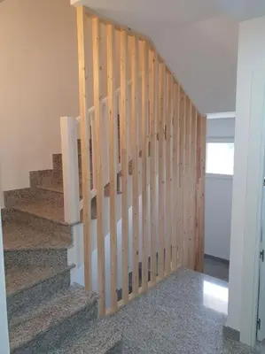 a staircase in a house with wooden railings at VUT Sierra Pambley in Villablino