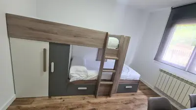 a bunk bed with a ladder in a room at VUT Sierra Pambley in Villablino