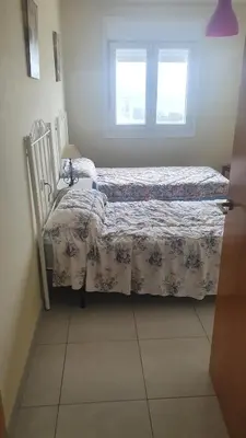 a bedroom with two beds and a window at Grecia in Barreiros