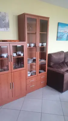 a large wooden cabinet in a living room with a couch at Grecia in Barreiros