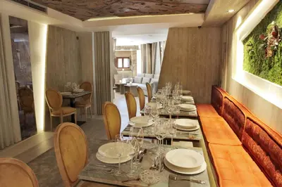 a dining room with a long table and chairs at Hotel Las Treixas in Puebla de Sanabria