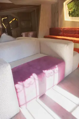 a living room with a couch with a purple rug on it at Hotel Las Treixas in Puebla de Sanabria