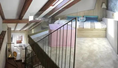 a bedroom with a bed and a staircase in a room at Hotel Las Treixas in Puebla de Sanabria