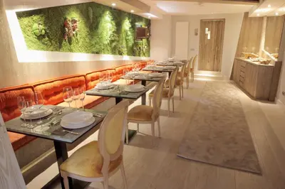 a long dining room with long tables and chairs at Hotel Las Treixas in Puebla de Sanabria