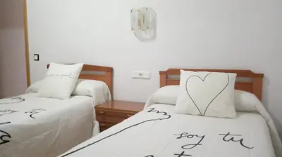 a room with two beds with a heart on them at Hostal 