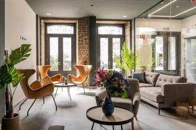 a living room with a couch and chairs at Coliving Compostela in Santiago de Compostela