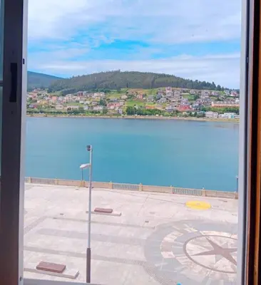 a window with a view of a large body of water at Los Leones in Viveiro