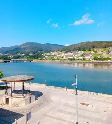 a gazebo next to a large body of water at Los Leones in Viveiro