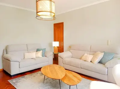 a living room with two couches and a coffee table at Los Leones in Viveiro