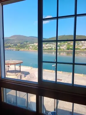 a view of a lake from a window at Los Leones in Viveiro