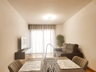 a living room with a table and a couch at milla sonsuites in Milladoiro