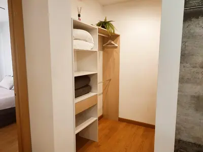 a closet with white shelves in a small room at milla sonsuites in Milladoiro