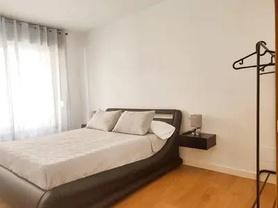 a bedroom with a bed and a window at milla sonsuites in Milladoiro