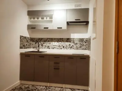 a kitchen with brown cabinets and a sink at milla sonsuites in Milladoiro