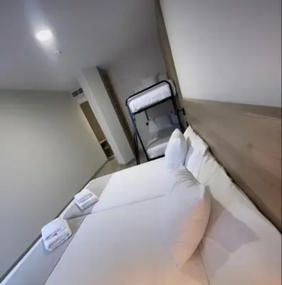a small room with a bed and a chair at URBAN Pensión in Melide
