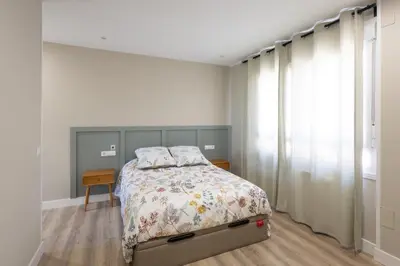 a bedroom with a bed and a window at Miño Suites I in Miño