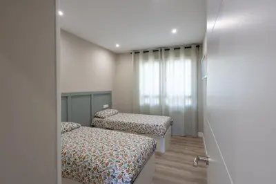 a bedroom with two beds and a window at Miño Suites I in Miño