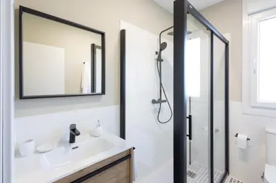 a bathroom with a sink and a shower at Miño Suites I in Miño