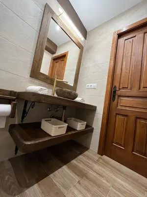 a bathroom with a sink and a mirror at La Casina de la Yeye San Cristóbal de Valdueza in San Cristóbal de Valdueza