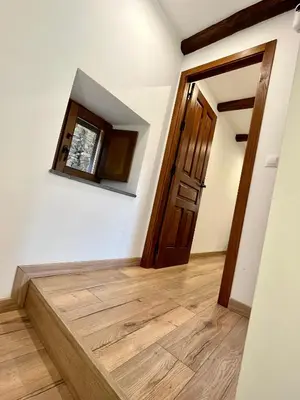 a hallway with a wooden floor and a door at La Casina de la Yeye San Cristóbal de Valdueza in San Cristóbal de Valdueza