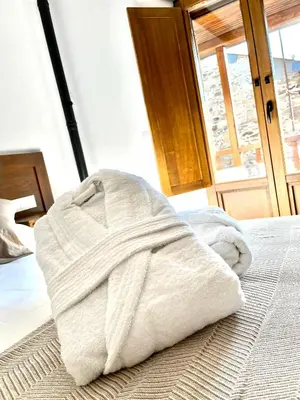 a white towel is sitting on a bed at La Casina de la Yeye San Cristóbal de Valdueza in San Cristóbal de Valdueza