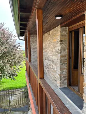 a porch of a house with a stone wall at La Casina de la Yeye San Cristóbal de Valdueza in San Cristóbal de Valdueza
