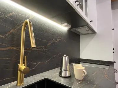 a kitchen counter with a sink and a faucet at La Casina de la Yeye San Cristóbal de Valdueza in San Cristóbal de Valdueza