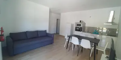 a living room with a blue couch and a table at Apartamentos Turísticos Magencio in Carucedo