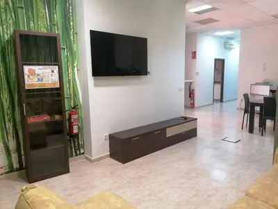 a living room with a flat screen tv on a wall at Albergue El Templarin in Ponferrada