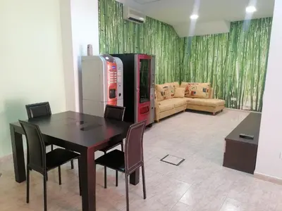a dining room with a table and a soda machine at Albergue El Templarin in Ponferrada