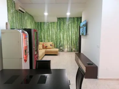 a kitchen with a black table and a refrigerator at Albergue El Templarin in Ponferrada