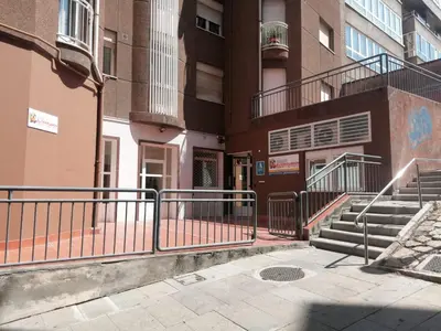 an apartment building with stairs and a stair railing at Albergue El Templarin in Ponferrada