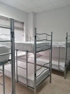 a group of bunk beds in a room at Albergue El Templarin in Ponferrada