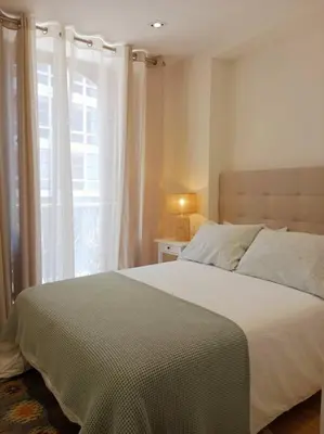 a bedroom with a large bed and a window at Ribeira in Vivero