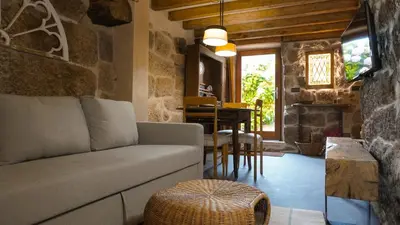 a living room with a couch and a table at Casa la Trinidad - Ribeira Sacra in Nogueira de Ramuin