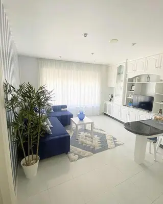 a living room with a blue couch and a table at Apartamento San Roque in Betanzos
