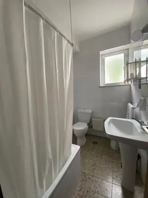 a bathroom with a toilet and a shower curtain at Alda Cabanas Playa in Cabañas