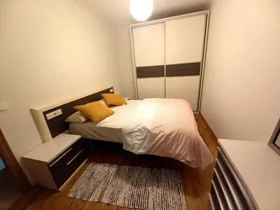 a small bedroom with a bed and a mirror at EnFOZ PLAYA DE LLAS in Foz