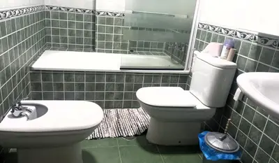a bathroom with a toilet and a sink and a tub at EnFOZ PLAYA DE LLAS in Foz