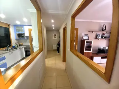 a hallway of a kitchen with a mirror at EnFOZ PLAYA DE LLAS in Foz
