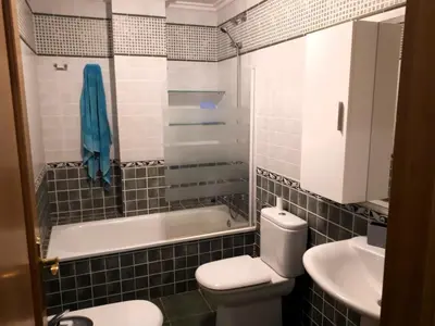 a bathroom with a toilet and a tub and a sink at EnFOZ PLAYA DE LLAS in Foz