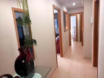 a hallway of a house with a mirror and a plant at EnFOZ PLAYA DE LLAS in Foz