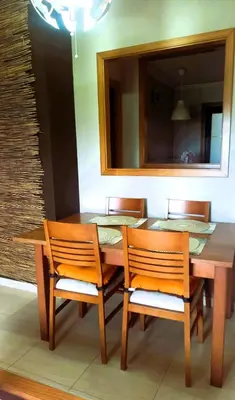 a dining room table with two chairs and a mirror at EnFOZ PLAYA DE LLAS in Foz