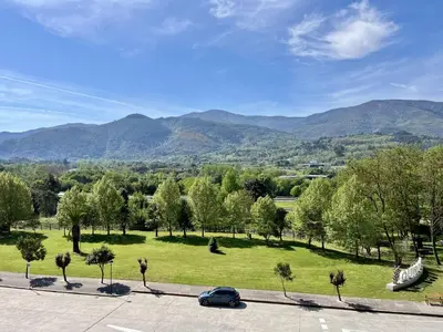 a car parked in a park with mountains in the background at Preciosas vistas en el corazón de la Riveira Sacra in Quiroga